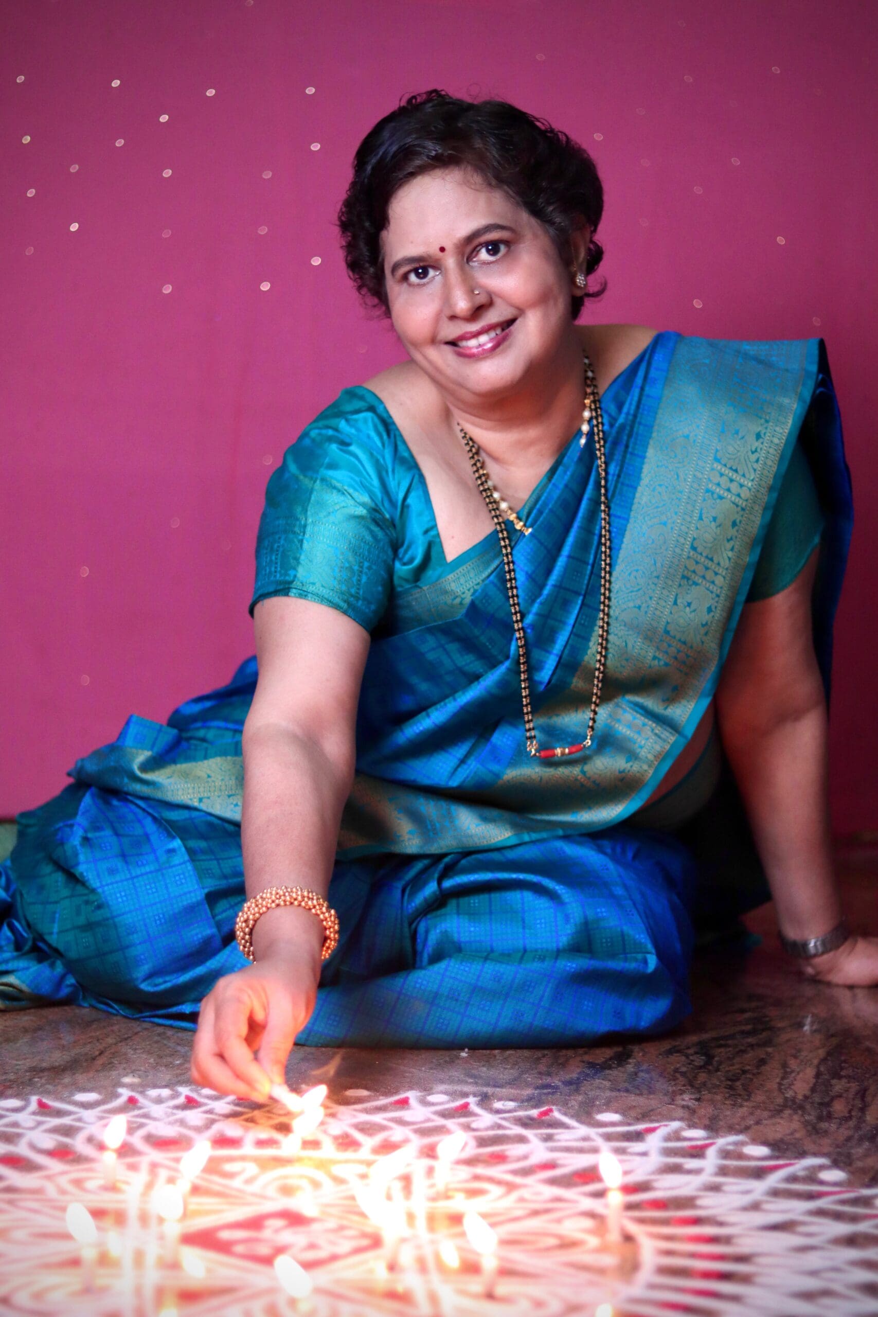 Indian aunty drawing kolam
