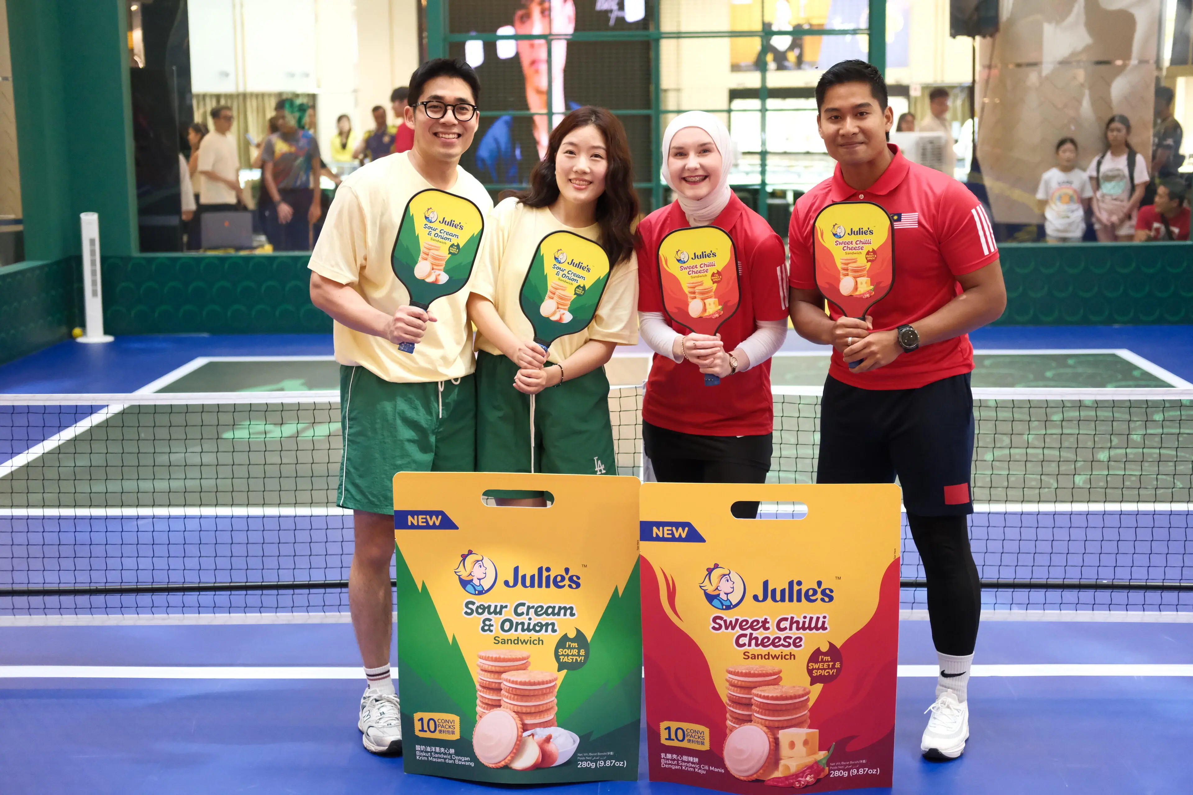 Content creators Alana & Abbas, and Seonma & Abang in a friendly pickleball match at the Julies Sweet Chilli Cheese and Sour Cream & Onion Roadshow