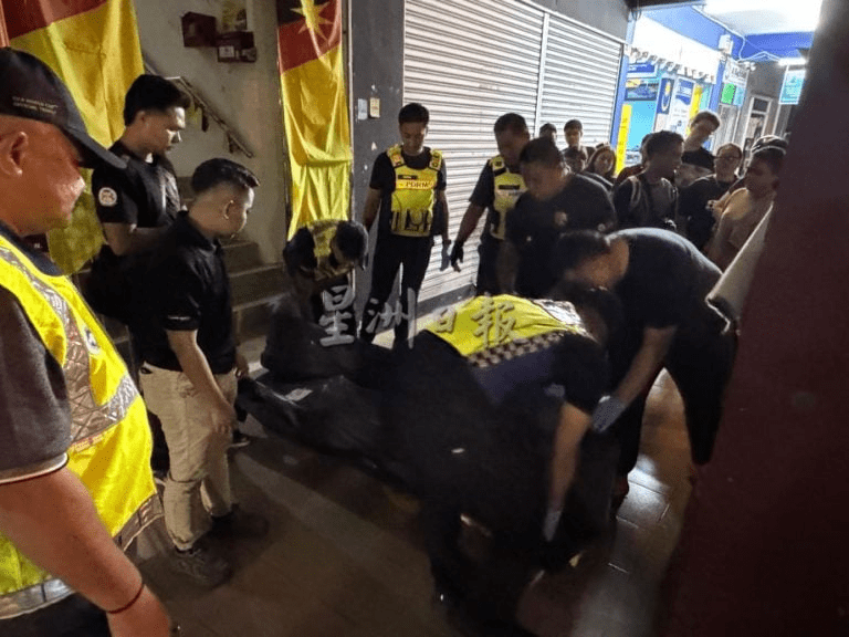 Police carry body of man who died in Sarawak hostel