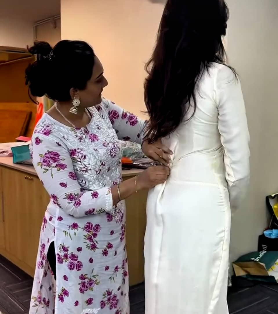 rekha designing at her tailor shop