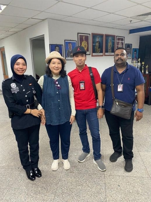 SG woman with police officers who helped find her luggage