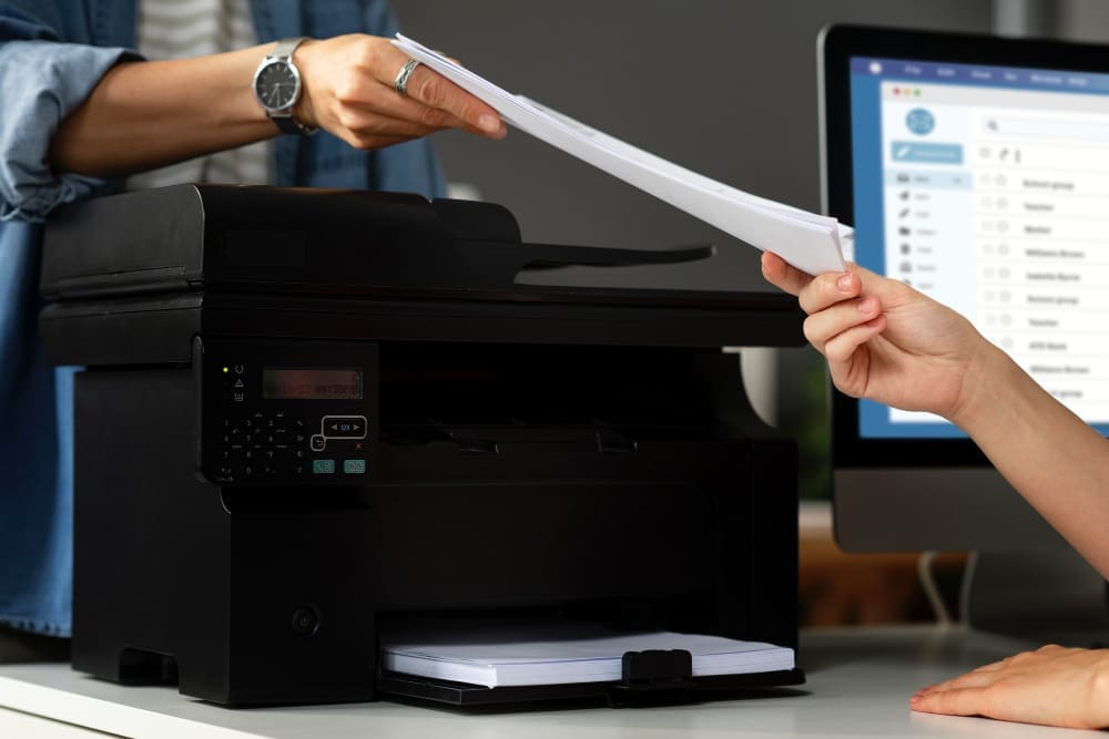 a person handing in a document to another