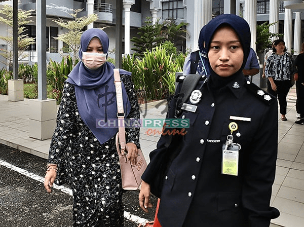Siti Hajar escorted by police