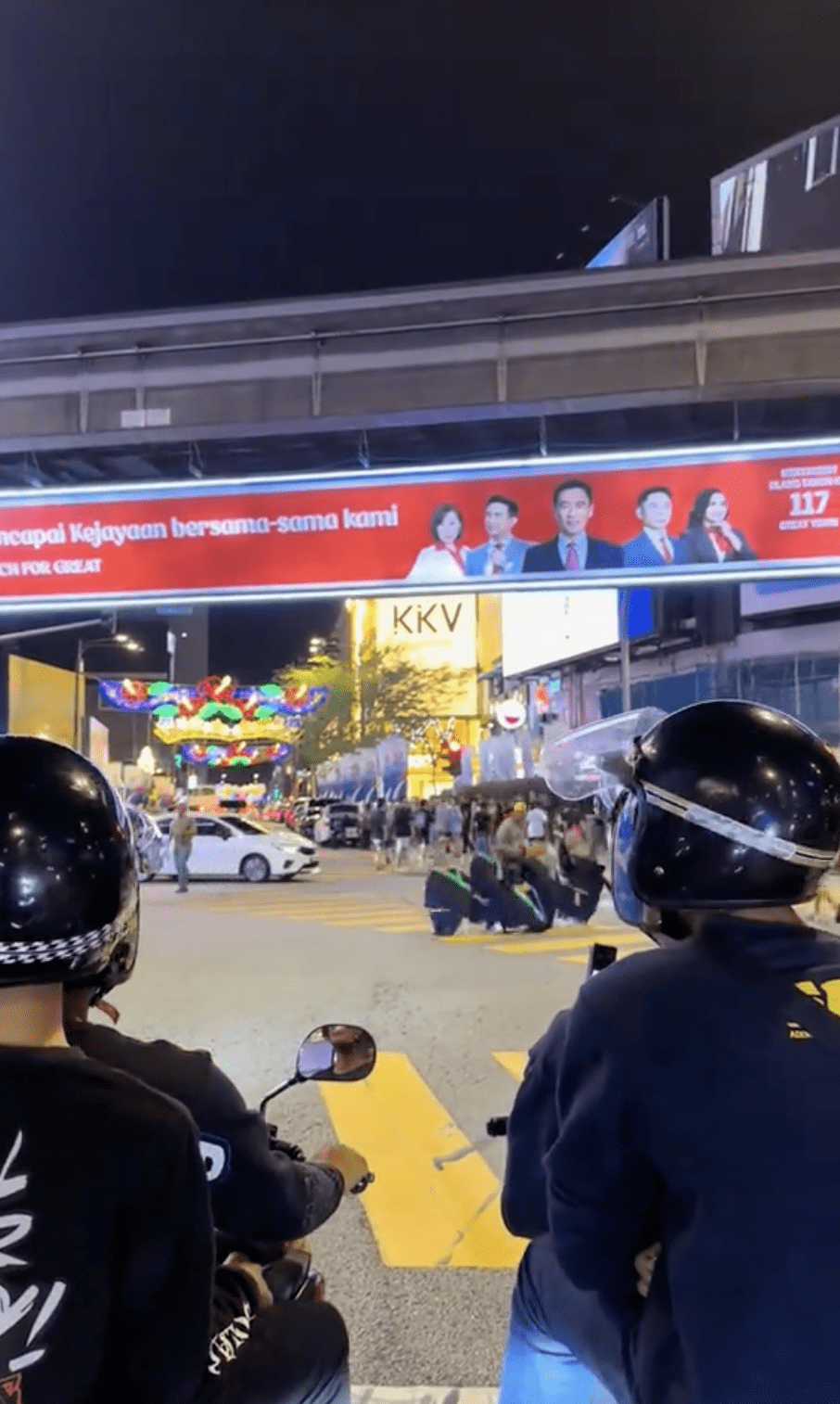 Students taking photos at bukit bintang intersection 02