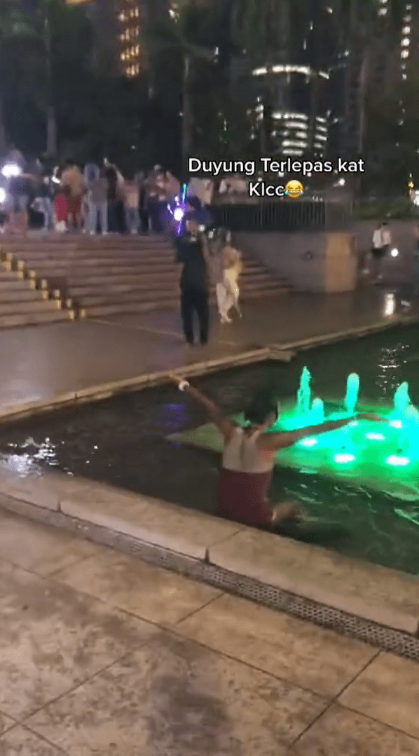 Woman In A Short Dress Swims Inside Water Fountain Near KLCC, Bystanders Yell ‘Out!’ At Her