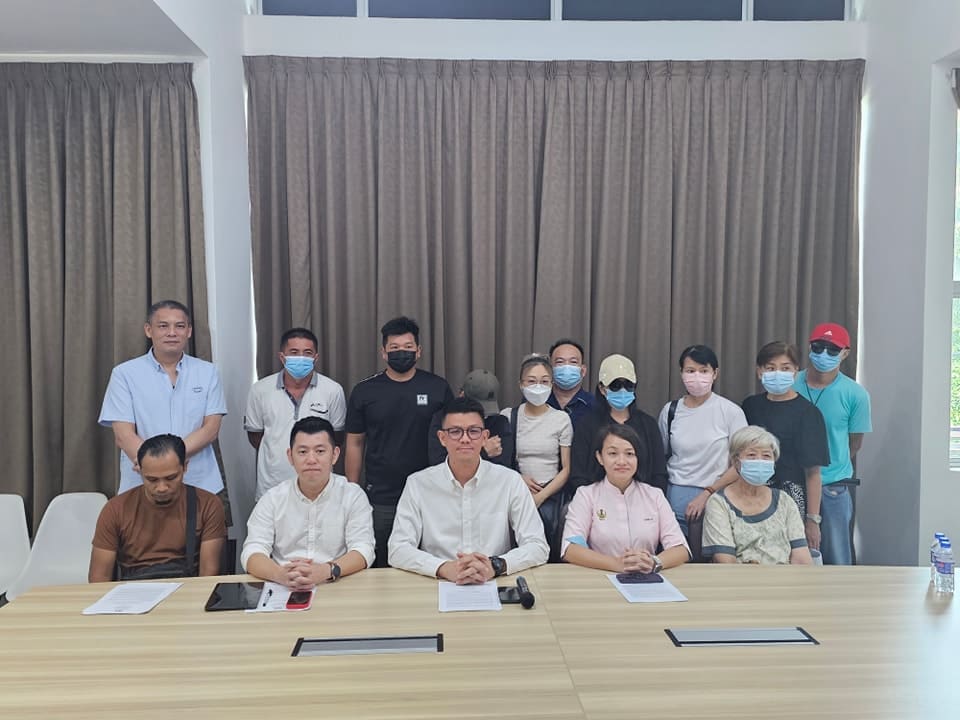 Tan Kar Hing with affected homeowners