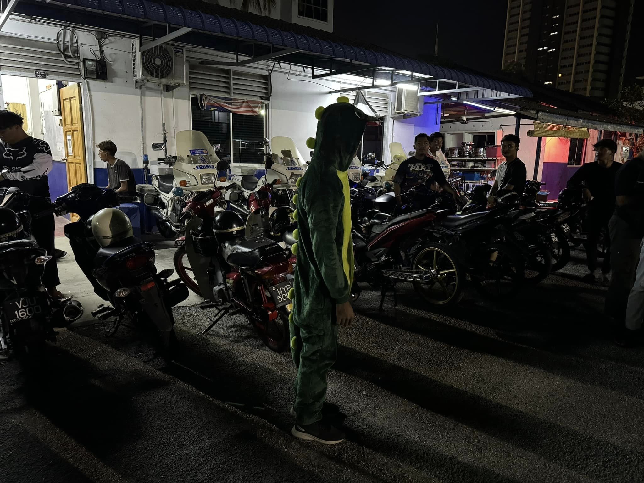M'sian teen stands while dressed in dino costume