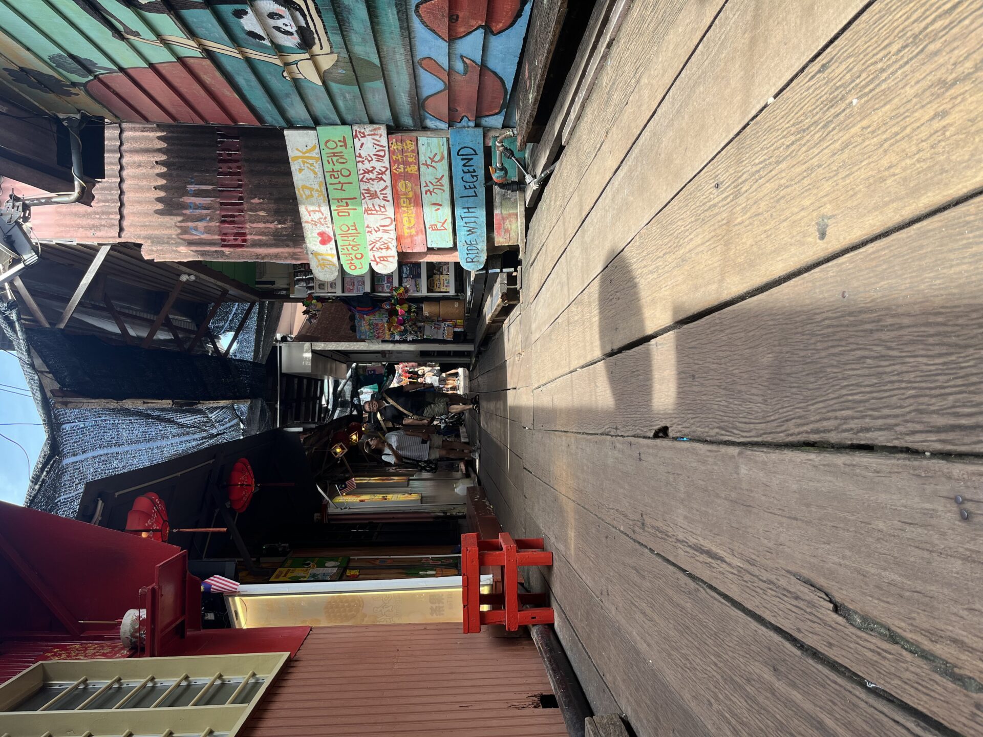 Tourists walking along Chew Jetty