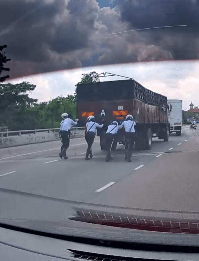 Traffic police pushing truck