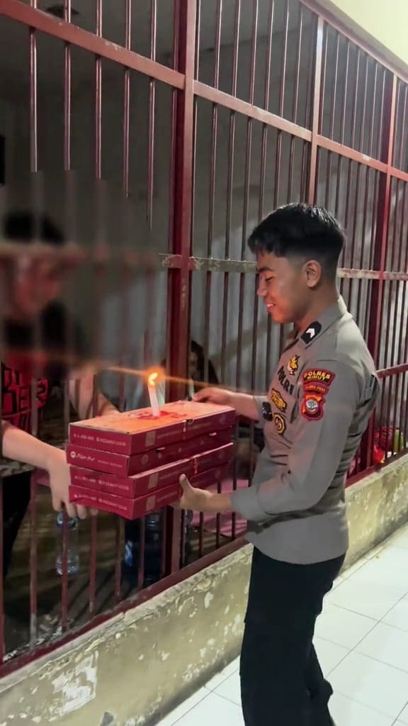 prison guard surprising inmate with pizza during his birthday