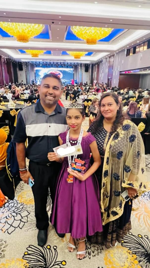 Punithamalar Rajashekar with her parents at an award ceremony