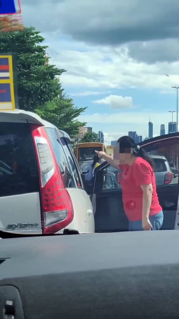 Msian woman yelling at another driver asking her to move her car. 