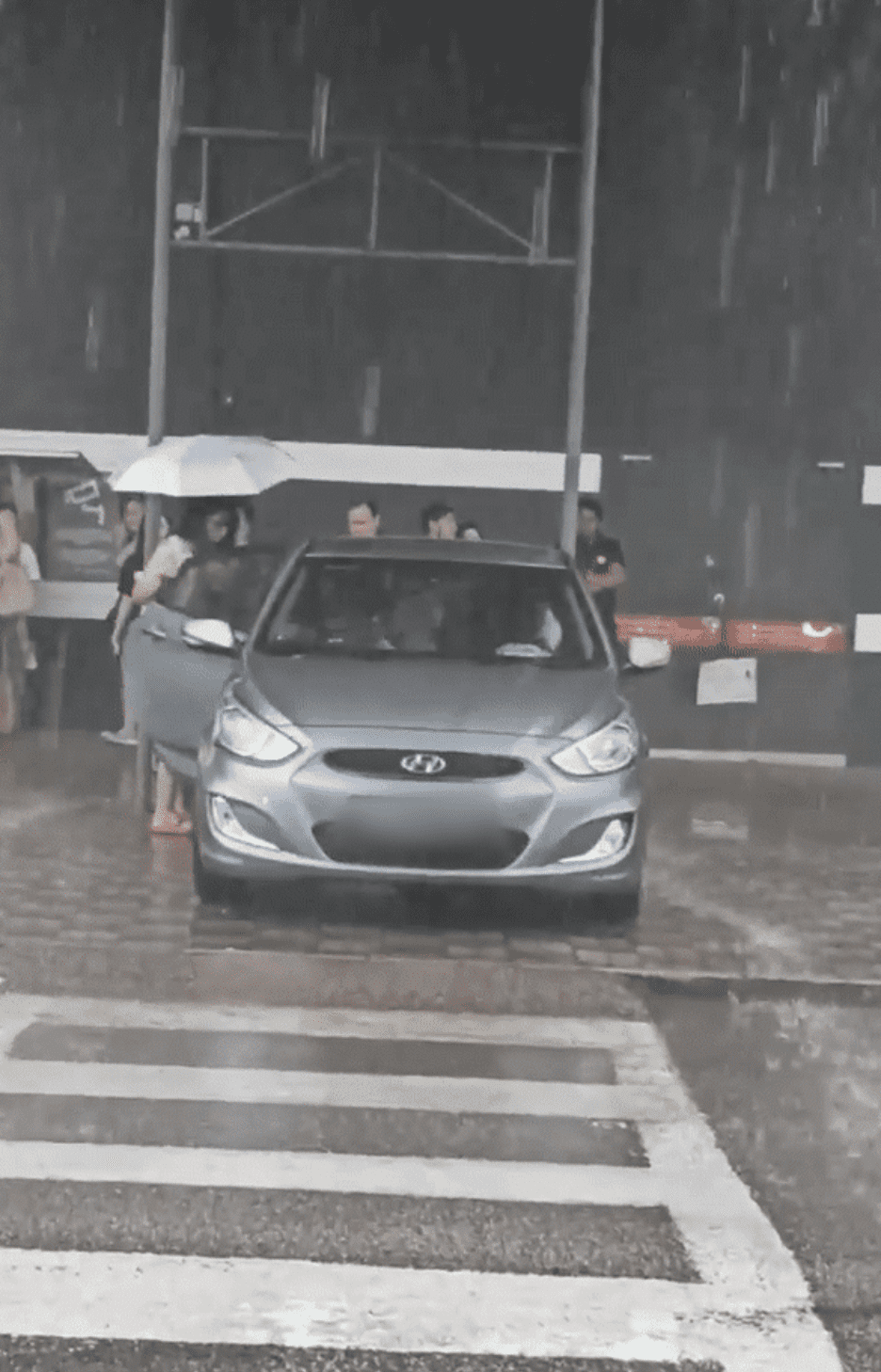 Woman exited from the SG registered Car