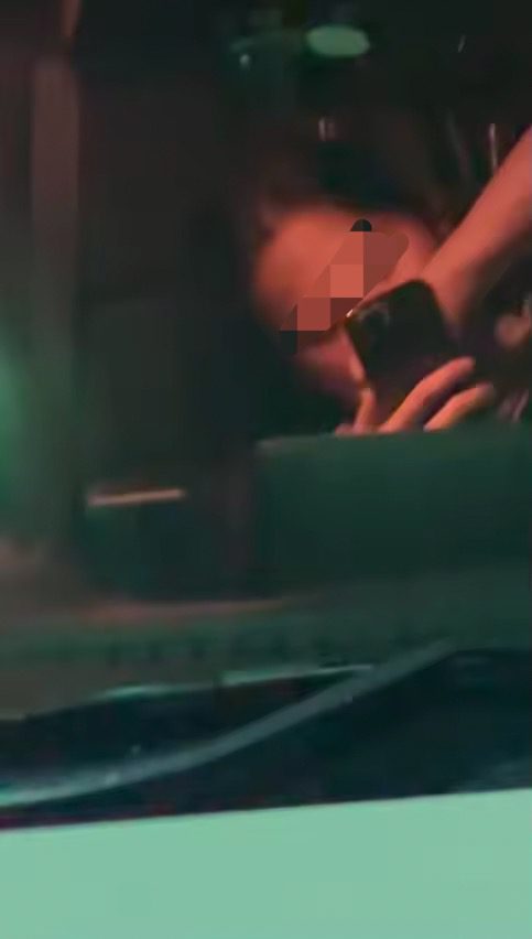 Woman looks at her phone inside SG-registered car