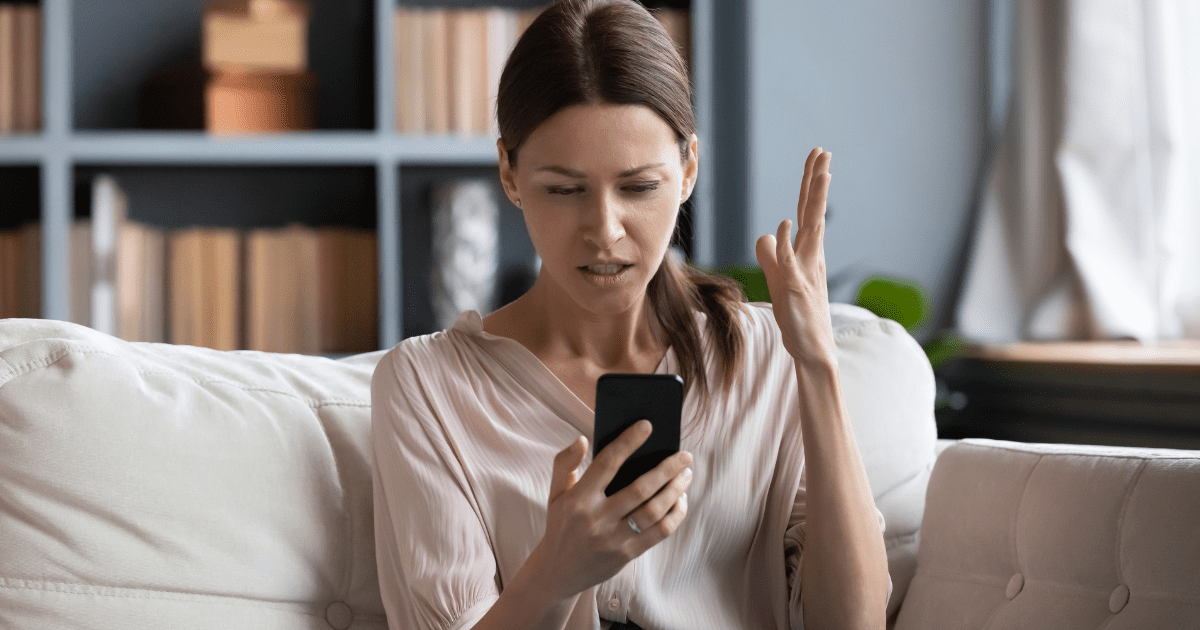 woman shocked looking at his phone