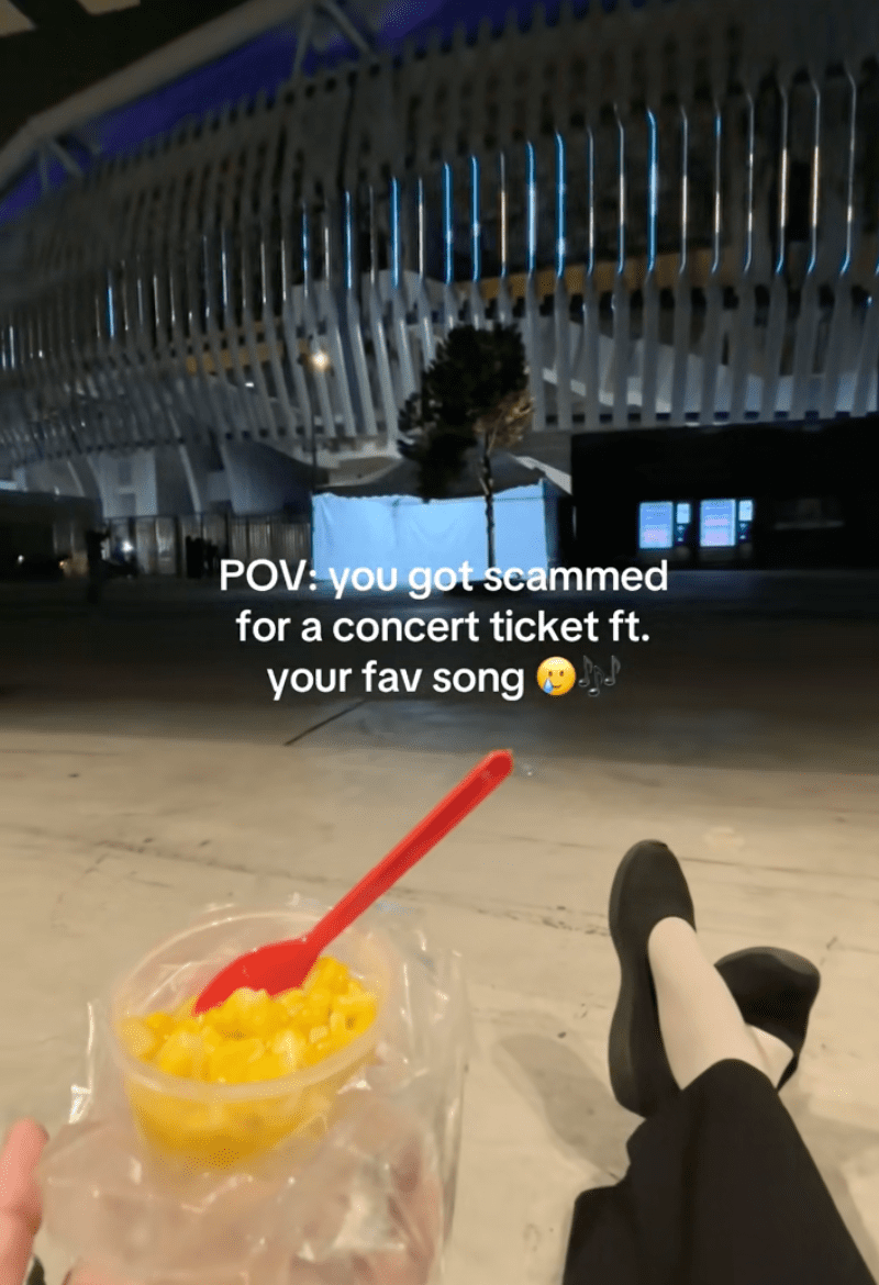 Woman sitting outside stadium for Siti Nurhaliza concert