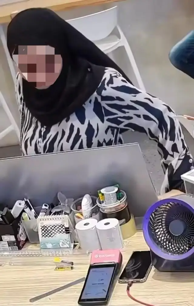 Woman stares at phone lying on the counter