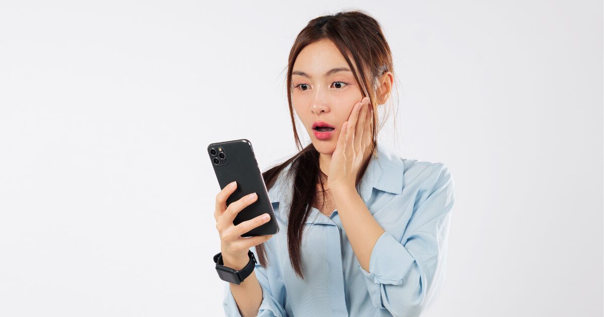 woman stunned looking at the phone