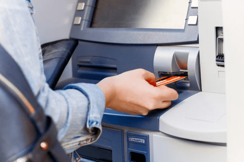 woman using ATM card