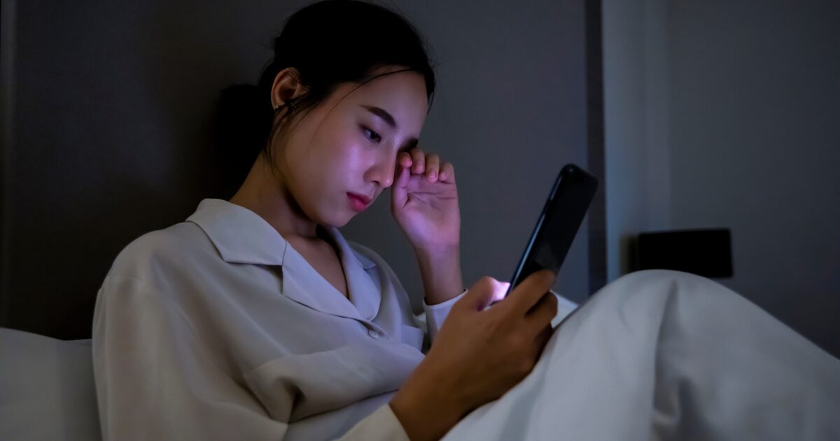 woman using phones at night