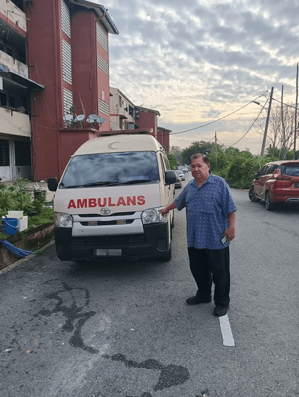 Ye posing with ambulance