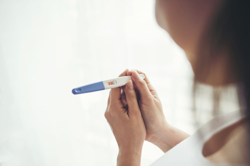 young-woman-hand-holding-pregnancy-test