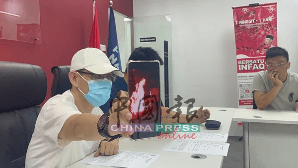 Zhu showing videos sent by loan sharks